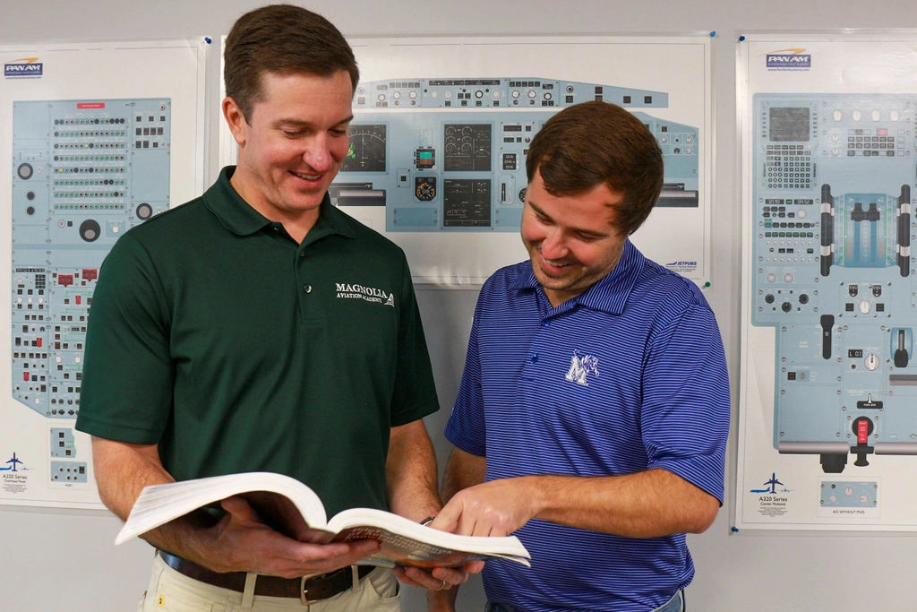 Magnolia Aviation Academy instructor and student reviewing flight training material