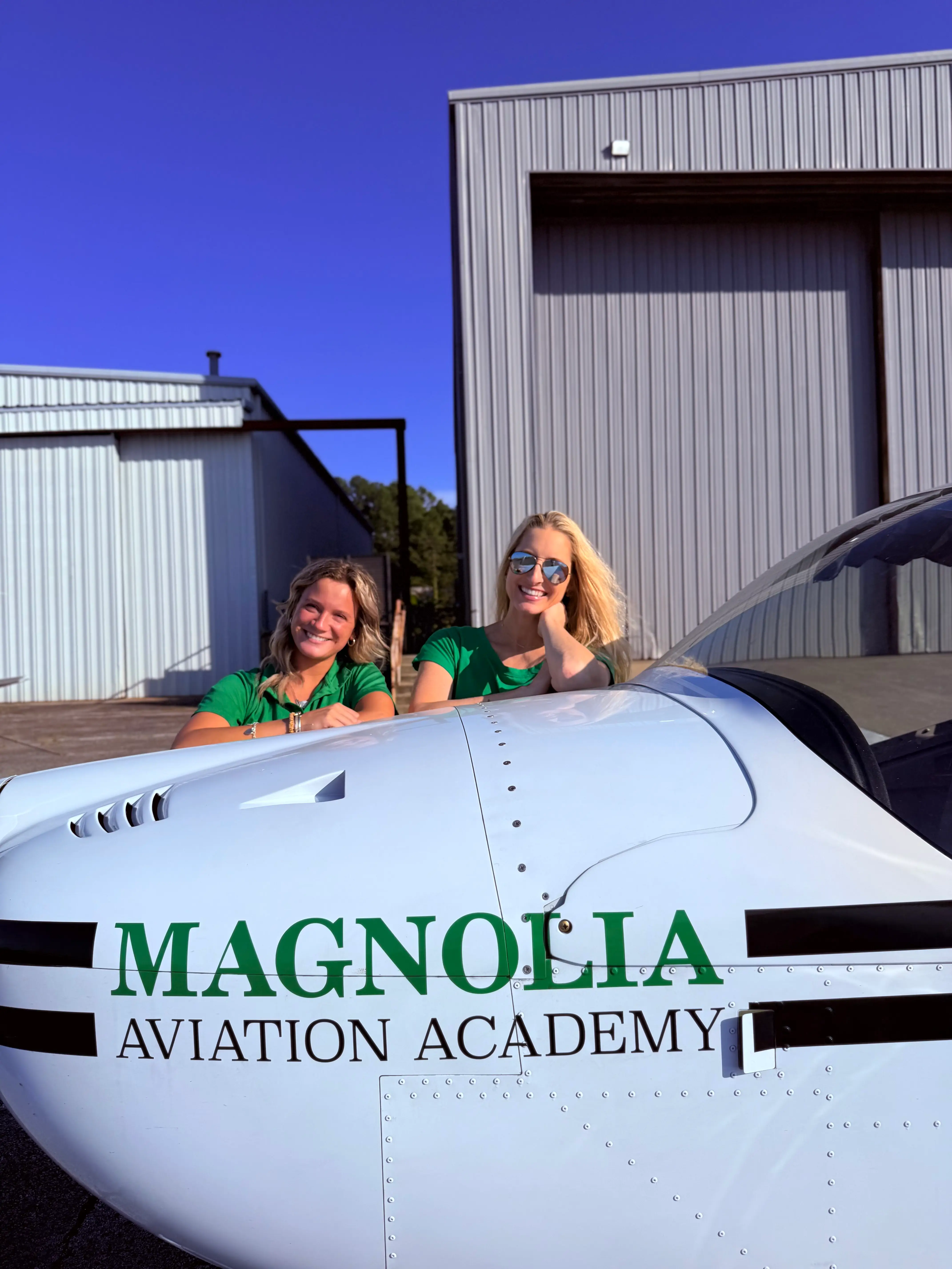 Magnolia Aviation Academy fleet aircraft two CFIs posing on top of RV